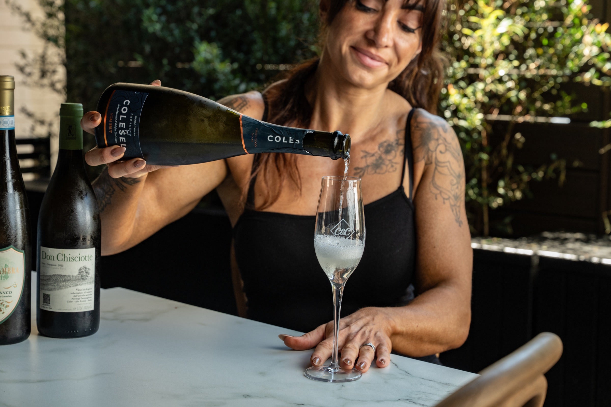 Alex pouring a restaurant-selected sparkling wine at Carne and Cucina
